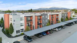 View of apartment building / complex featuring covered parking and a mountain view