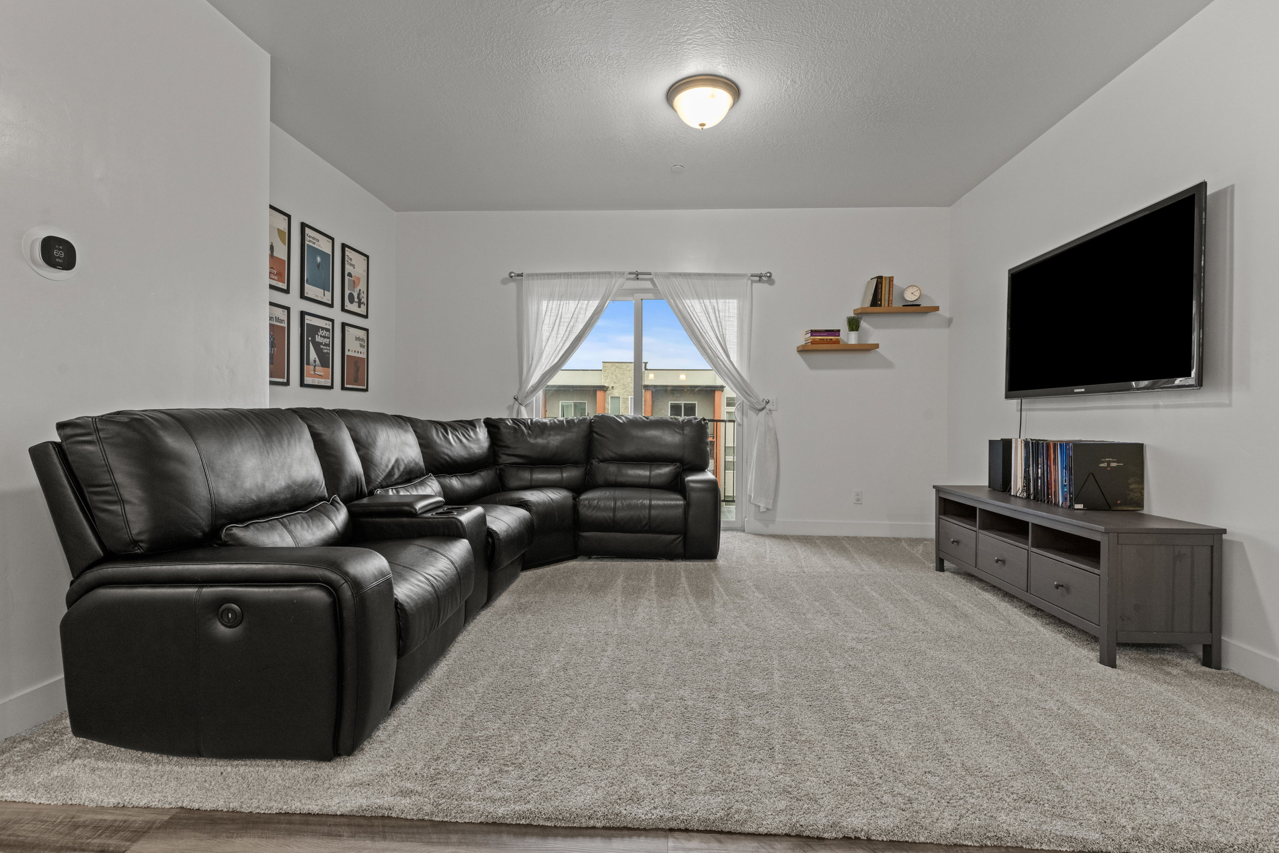 Living room featuring light carpet and a textured ceiling