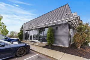 View of side of home featuring uncovered parking