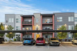 View of apartment building / complex with covered parking