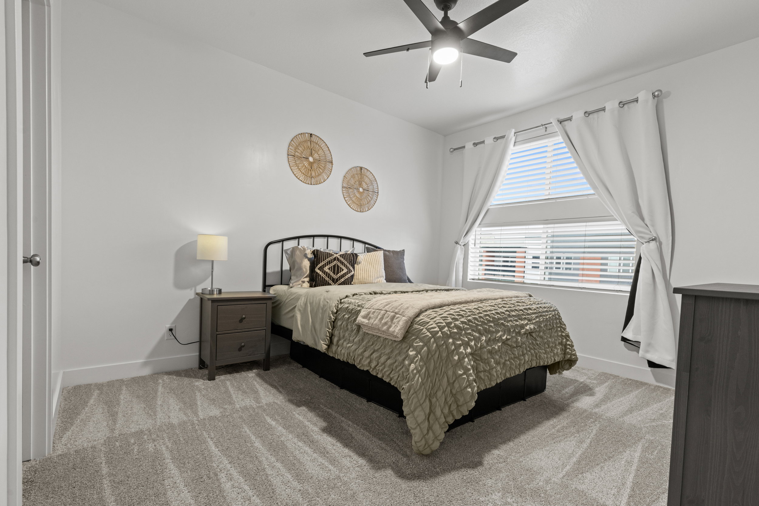 Bedroom featuring light colored carpet and ceiling fan