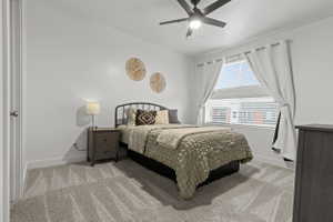 Bedroom featuring light colored carpet and ceiling fan