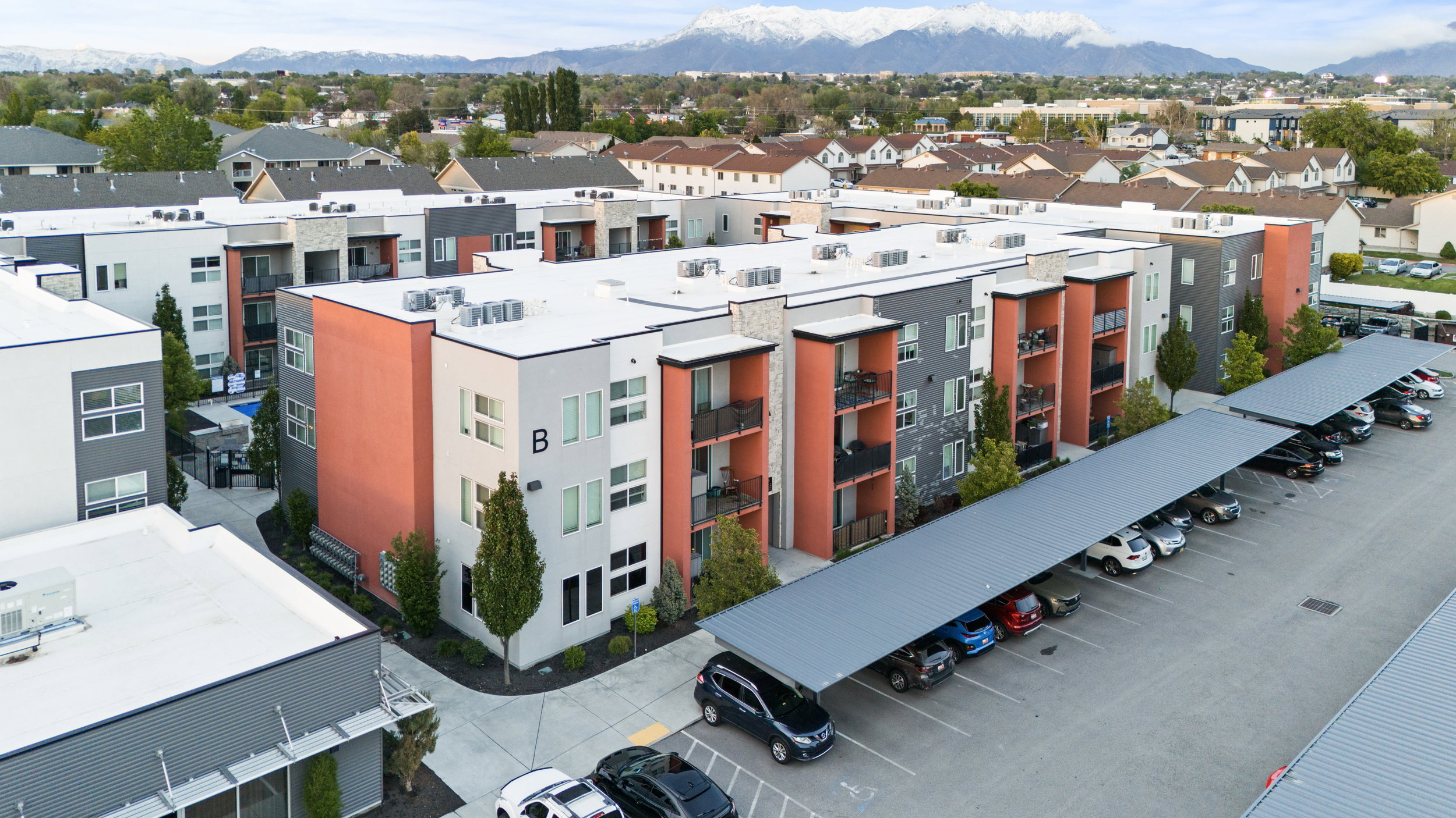 Aerial view of a mountainous background and apartment complex