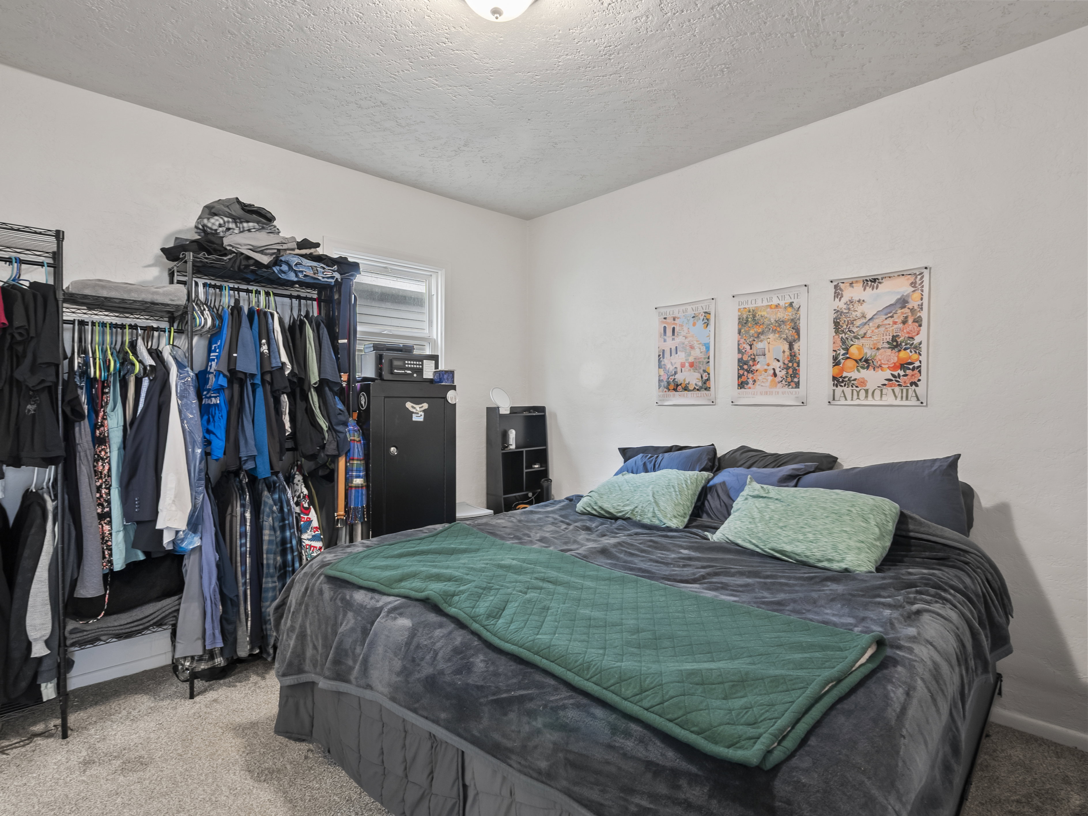 Bedroom with carpet floors and a textured ceiling