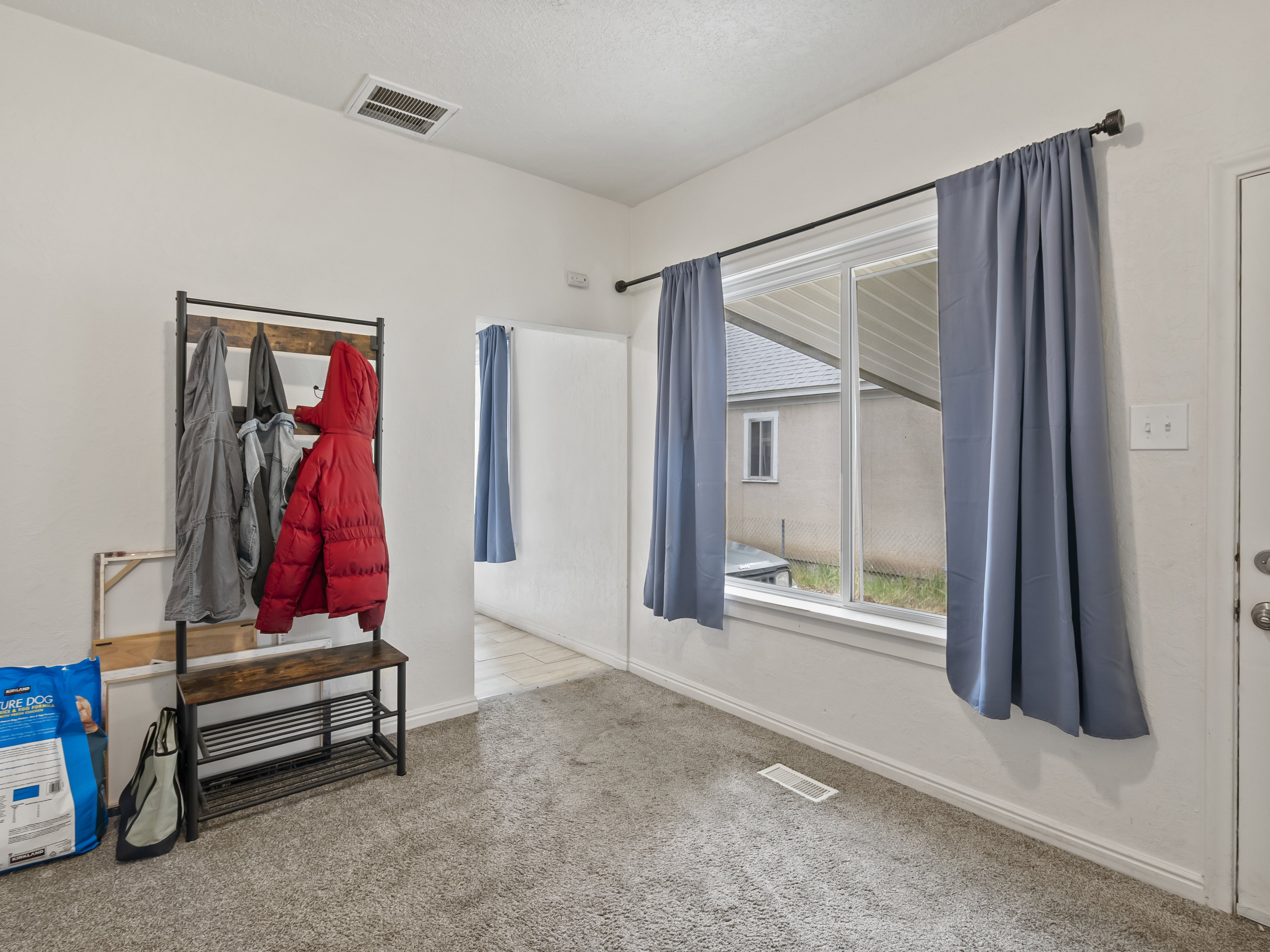 Empty room with baseboards and light colored carpet