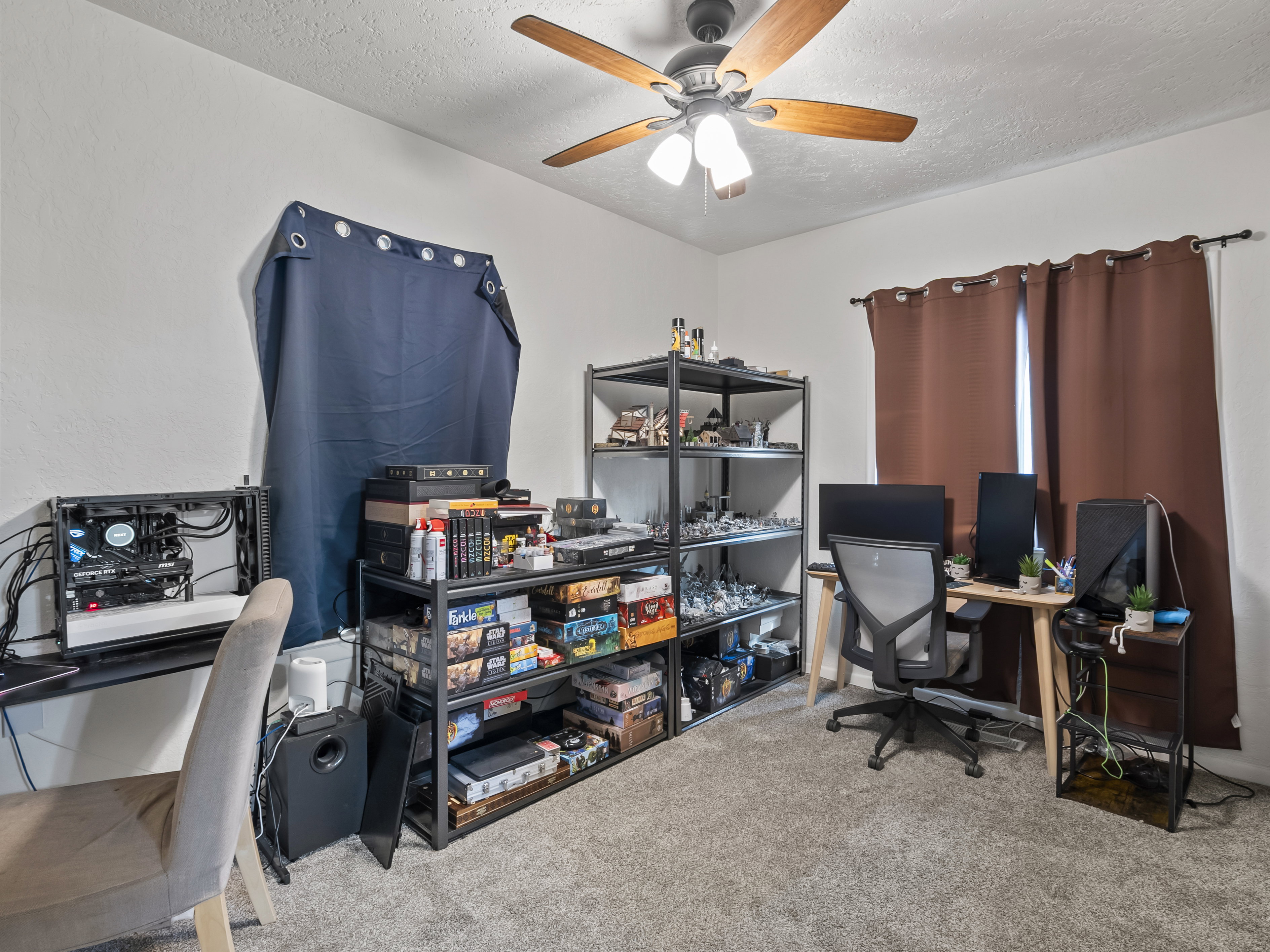 Home office with light carpet, a textured ceiling, and a ceiling fan