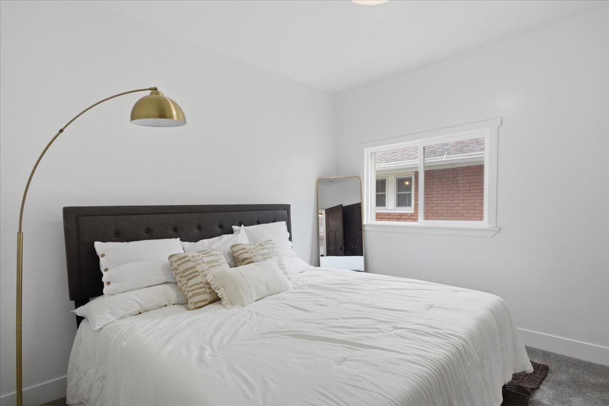 Bedroom featuring baseboards and carpet floors