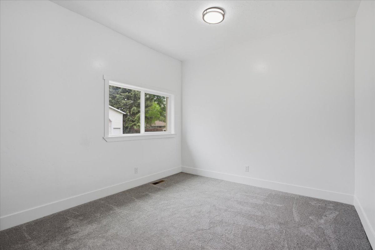 Empty room featuring carpet floors and baseboards