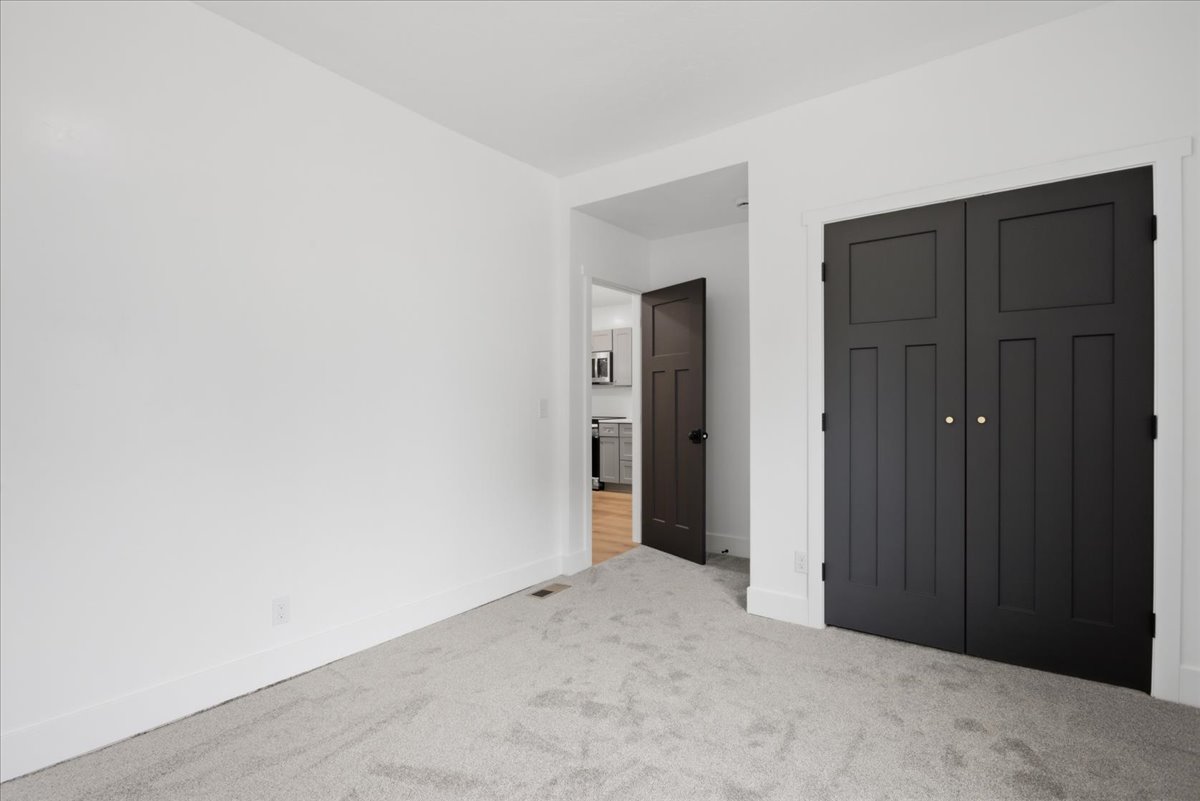 Unfurnished bedroom with a closet and light colored carpet