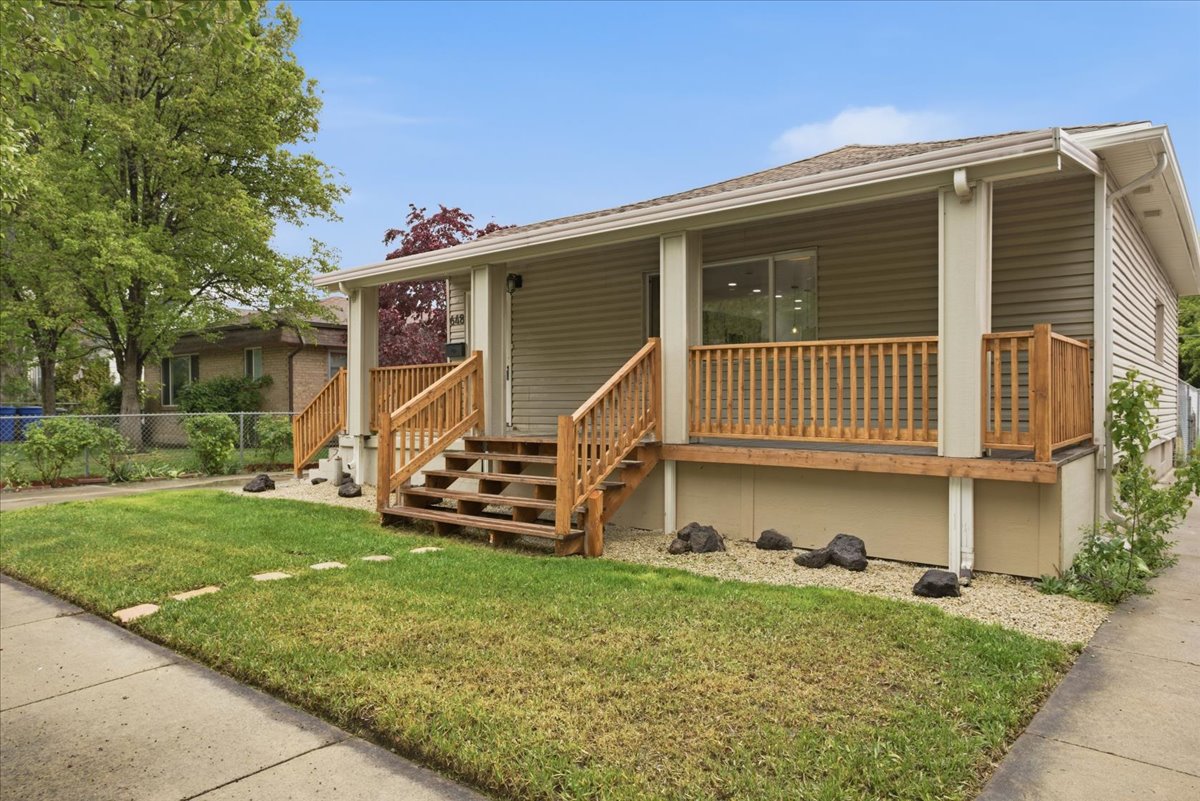 View of front of home with a porch and stairs