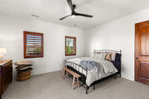 Bedroom with light carpet and a ceiling fan