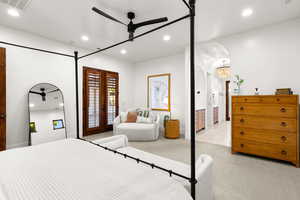 Bedroom featuring recessed lighting, light carpet, a ceiling fan, arched walkways, and access to outside