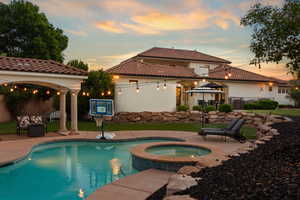 Combined pool / hot tub with a patio, a gazebo, and outdoor furniture