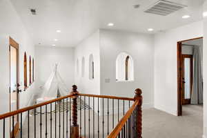 Corridor with carpet flooring, recessed lighting, and an upstairs landing