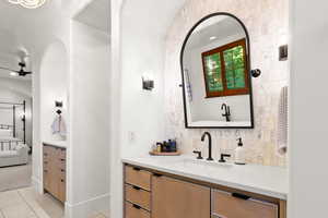 Bathroom with ensuite bath, vanity, backsplash, recessed lighting, and light tile patterned floors