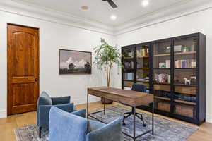 Home office featuring light wood-style flooring and a ceiling fan