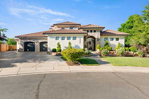 Mediterranean / spanish home featuring stone siding, an attached garage, concrete driveway, and stucco siding