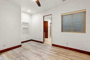 Empty room with light wood-style flooring, a ceiling fan, and recessed lighting