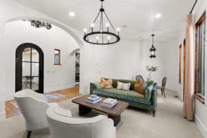 Living room with a chandelier and arched walkways