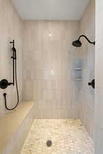 Bathroom featuring a tile shower