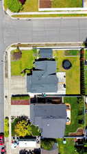 Aerial perspective highlighting a residential property with a dark shingle roof
