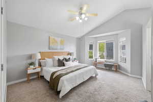 Bedroom featuring lofted ceiling, ceiling fan, and light carpet