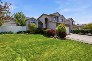 View of front of property featuring stucco siding, concrete driveway, and brick siding