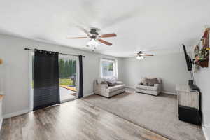 Living room featuring light wood finished floors and a ceiling fan