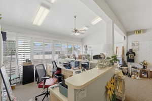 Office with vaulted ceiling and ceiling fan