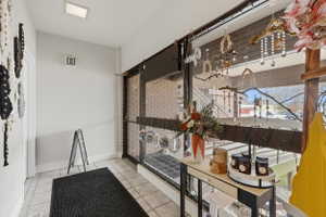 Interior space featuring light tile patterned flooring and baseboards