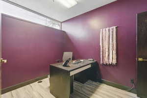Office featuring light wood-style floors and a textured ceiling