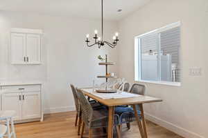 Dining room featuring light wood finished floors and suspended lighting