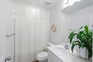 Bathroom featuring vanity and shower / bath combination with curtain