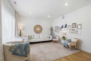 Living area featuring light wood-type flooring and recessed lighting