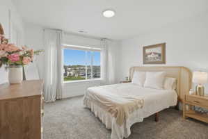 Bedroom featuring light carpet