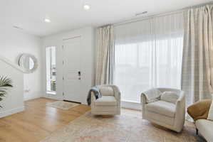 Entryway with light wood-style flooring and recessed lighting