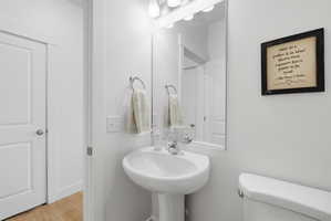Bathroom featuring toilet and light wood-type flooring