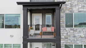 Property entrance with stone siding