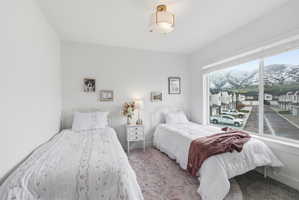 Carpeted bedroom with a mountain view and baseboards