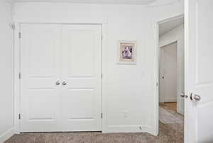 Unfurnished bedroom with carpet flooring and a closet