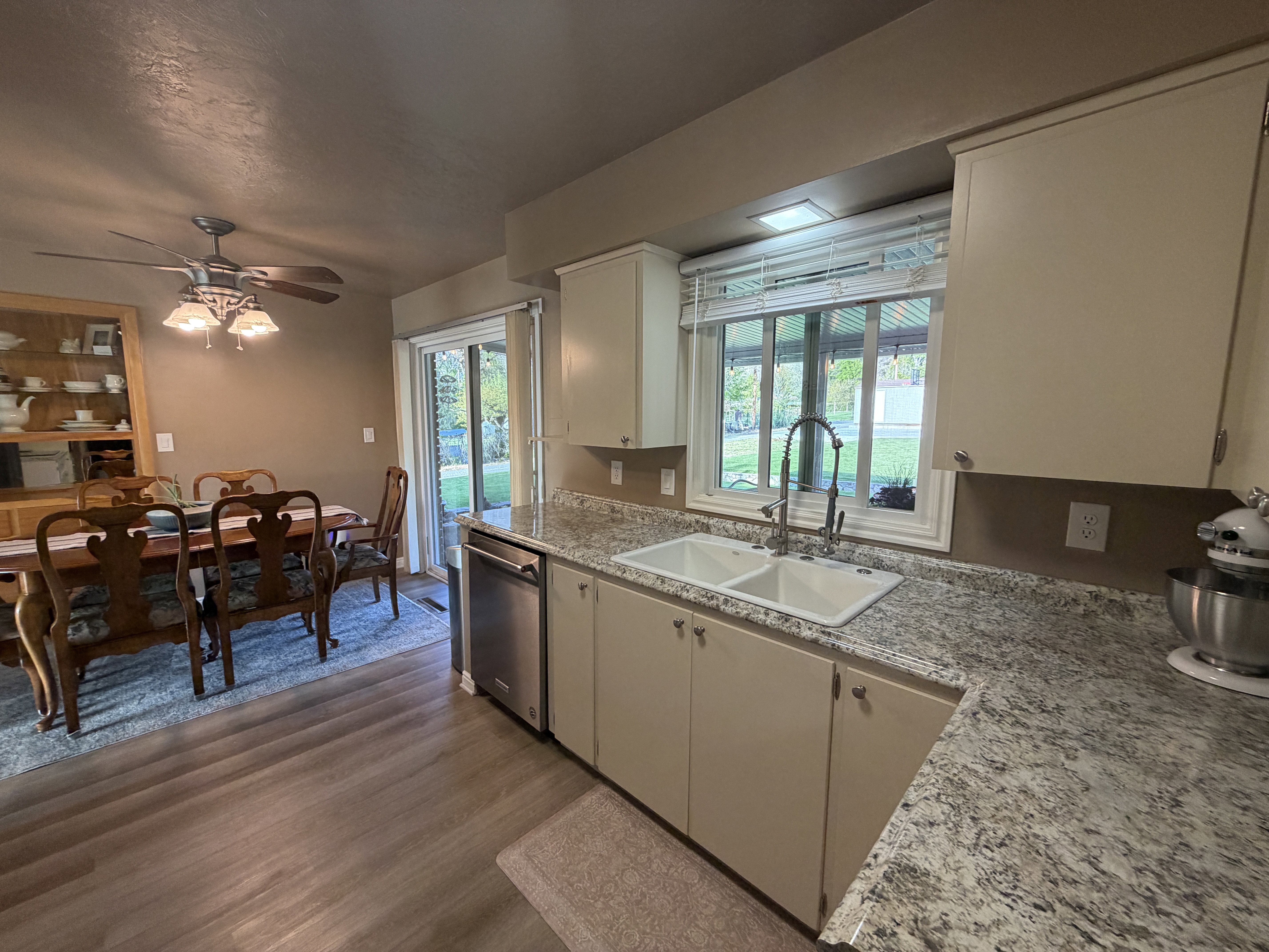 Kitchen featuring a ceiling fan, LVP floors, and dishwasher