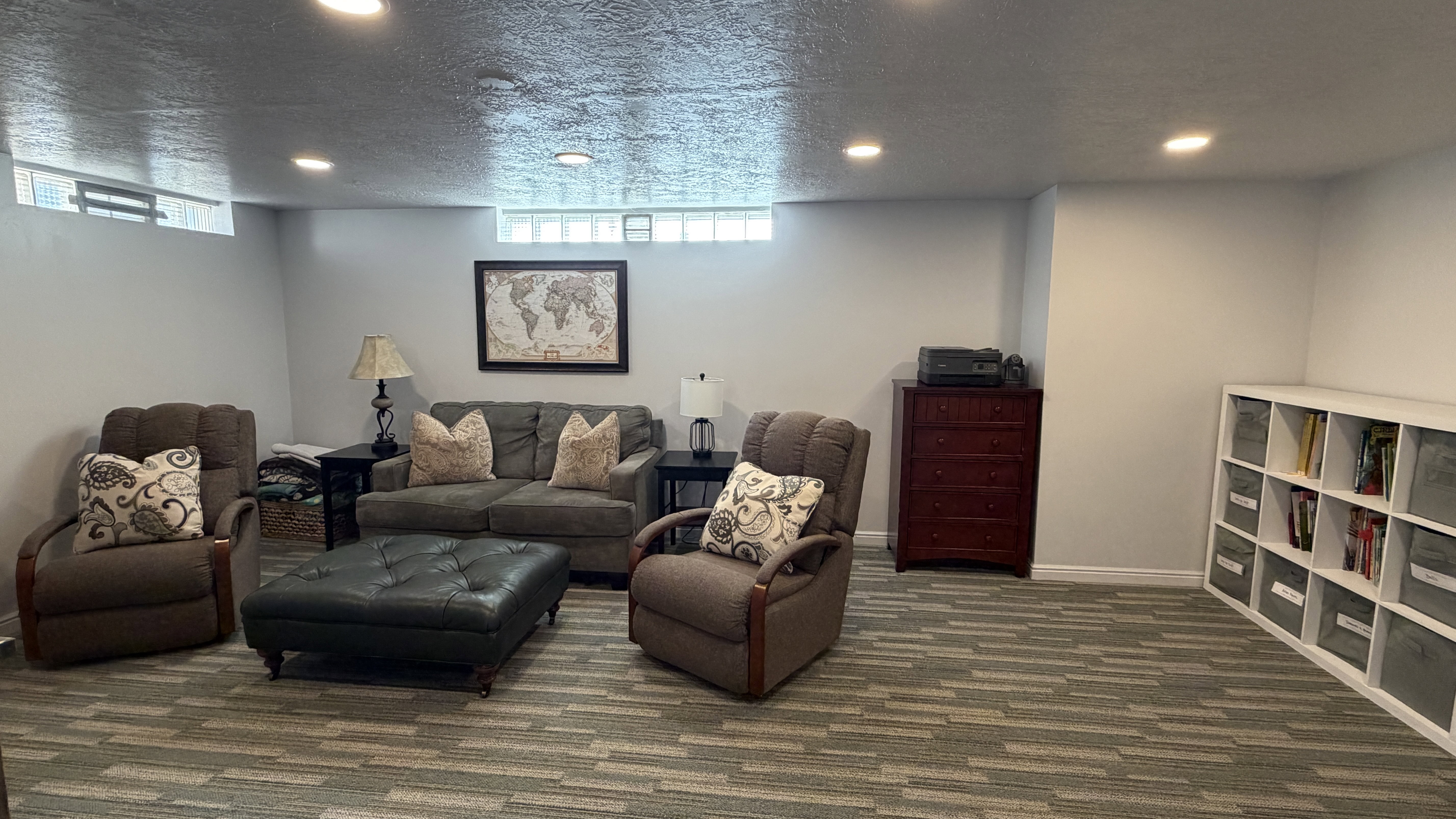 Family featuring carpet, recessed lighting, and a textured ceiling