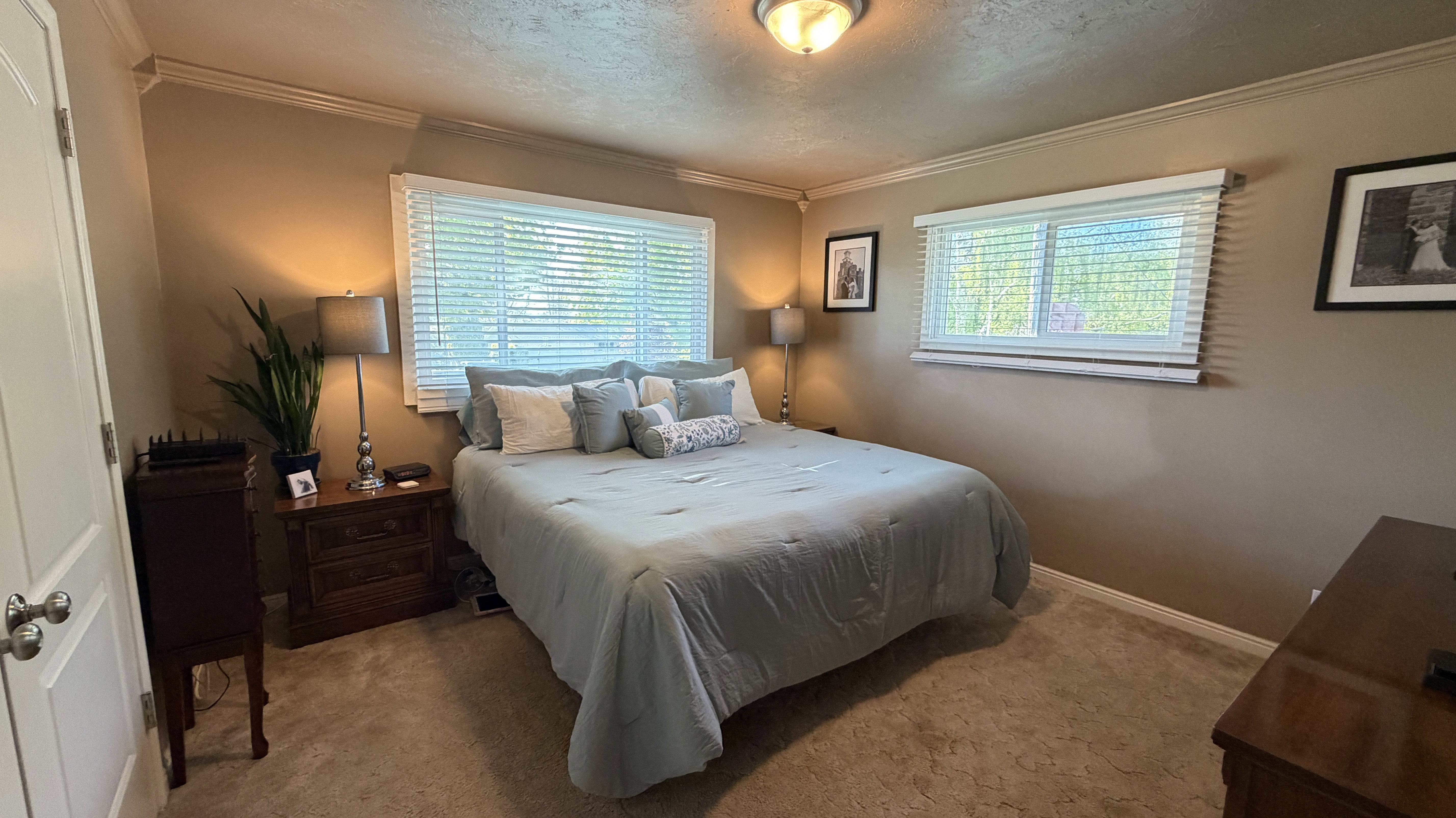 Carpeted bedroom 1 with a textured ceiling and ornamental molding