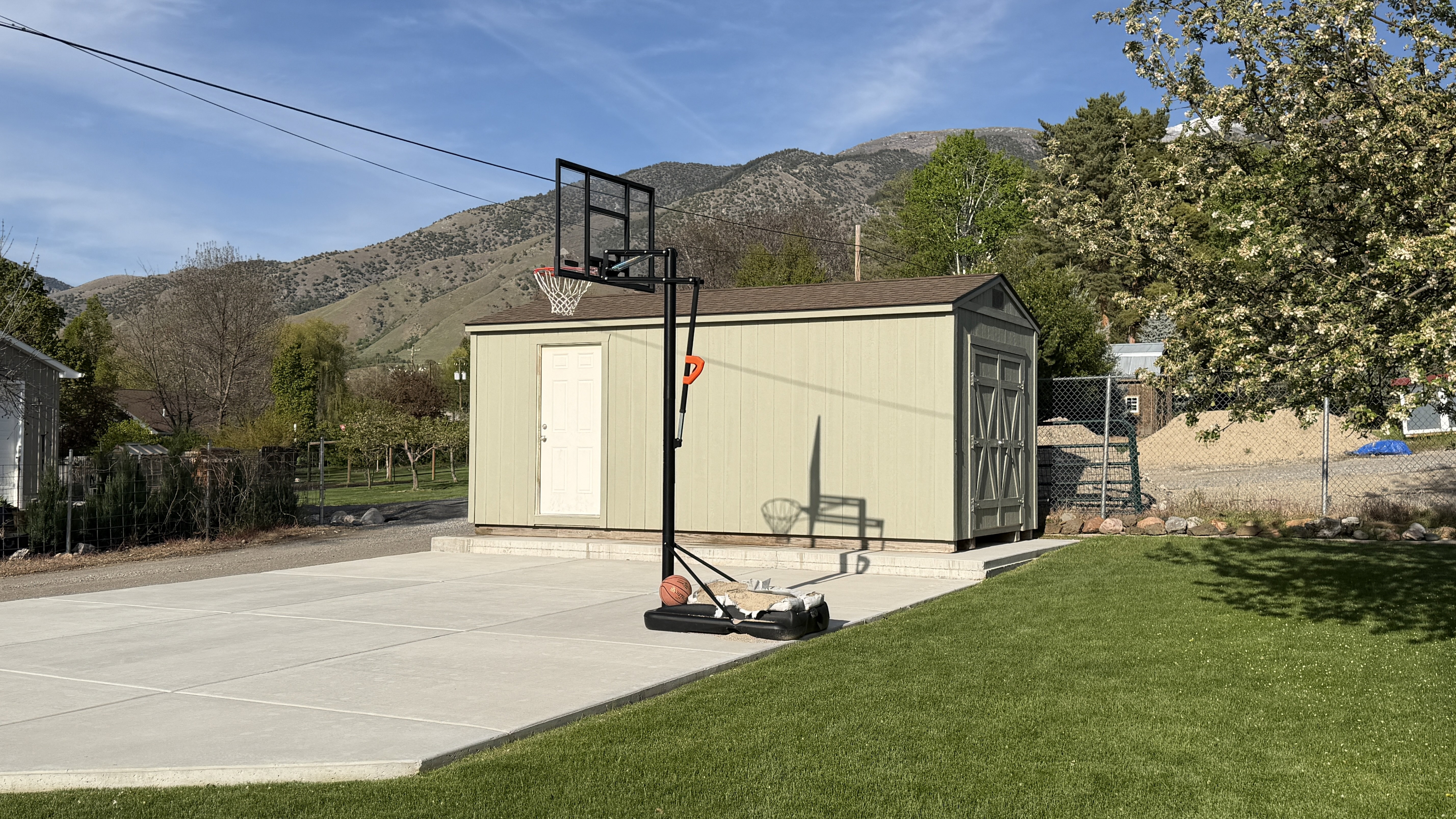 Concrete pad, basketball/game area and shed