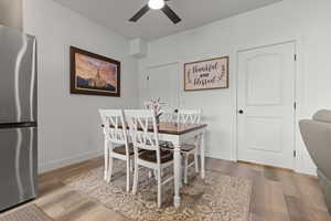 Dining space featuring wood finished floors and ceiling fan