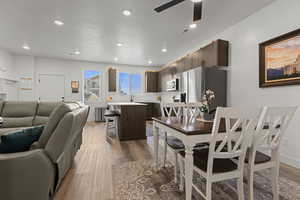 Dining space featuring light wood-type flooring, ceiling fan, and recessed lighting