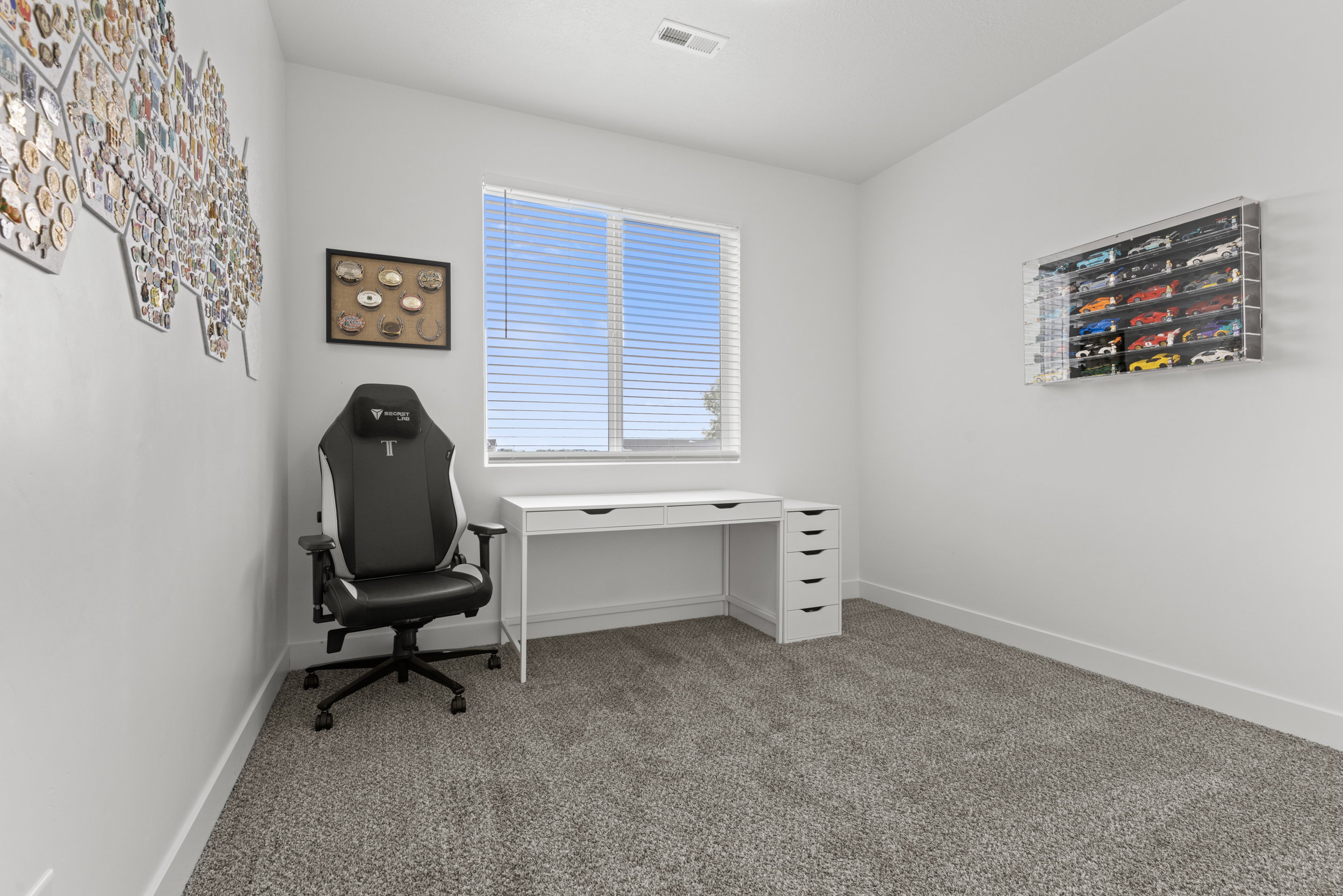 Office with light colored carpet and baseboards