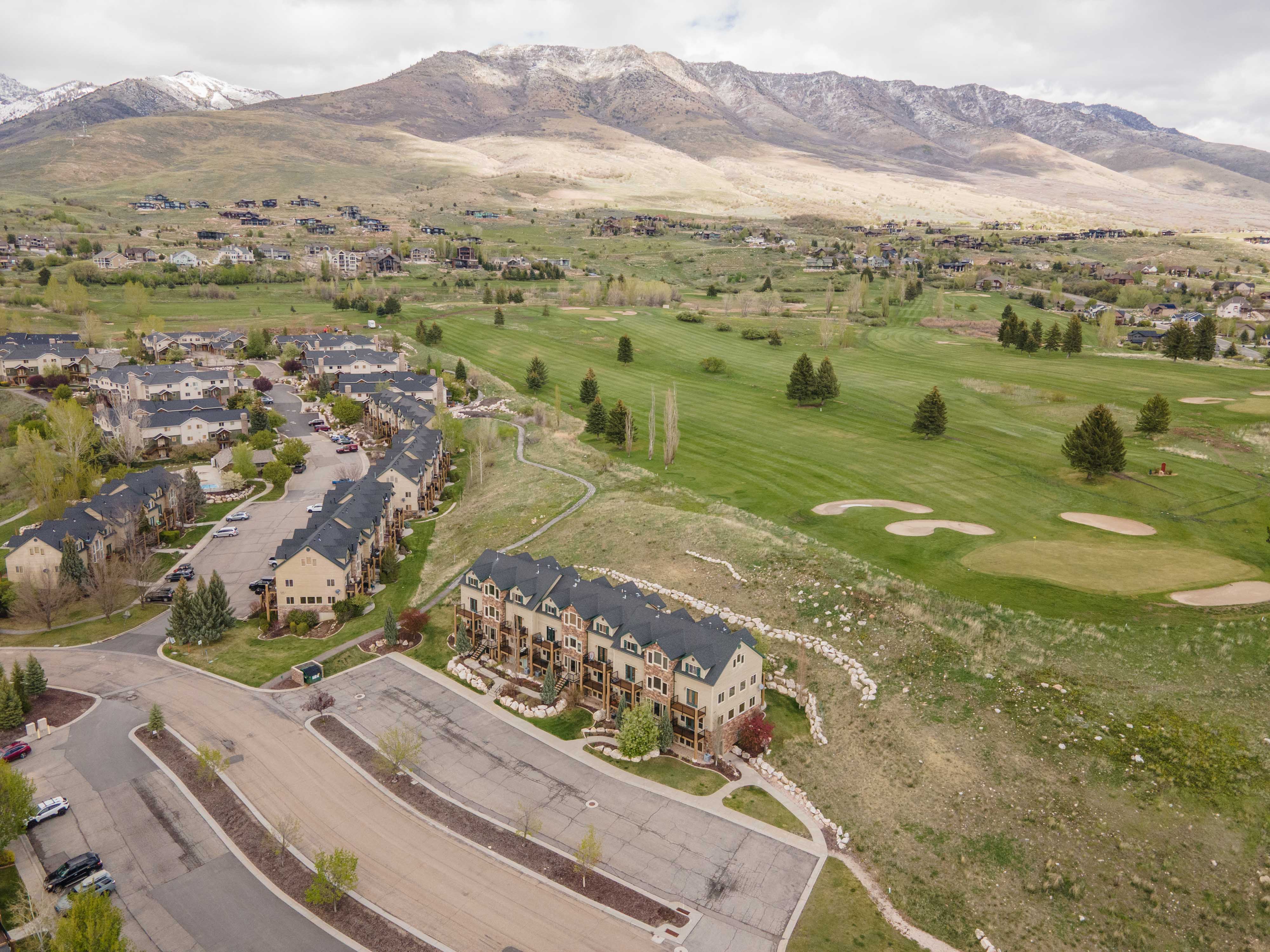 Bird's eye view of a mountainous background and a golf course