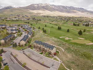 Bird's eye view of a mountainous background and a golf course