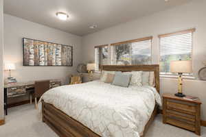 Bedroom featuring a desk and light colored carpet